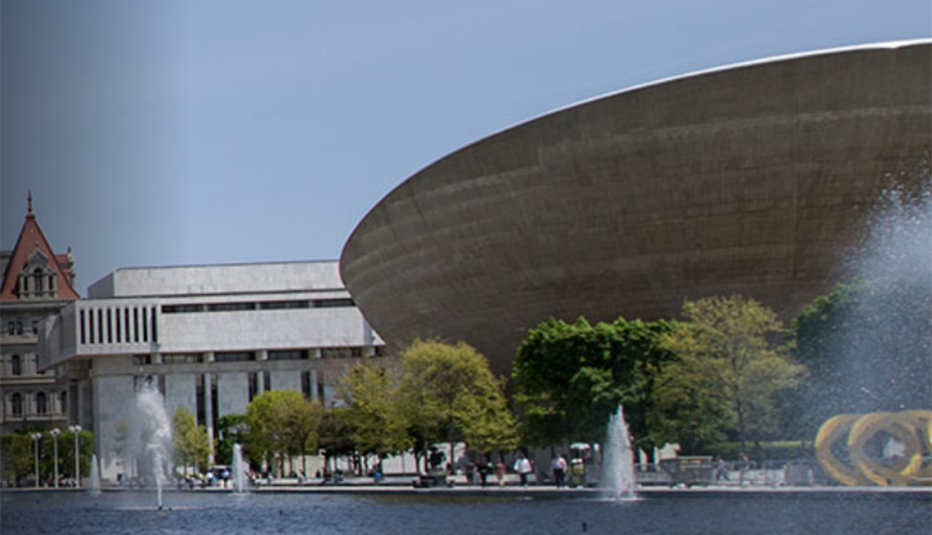 New York State Secure Choice Savings Program city image with buildings and water fountains in foreground
